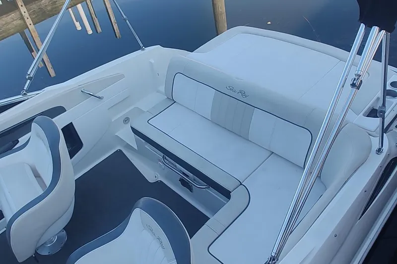 Slide: The Image of 2013 Sea Ray 220 Sundeck interior with white seating and sleek design. - 10