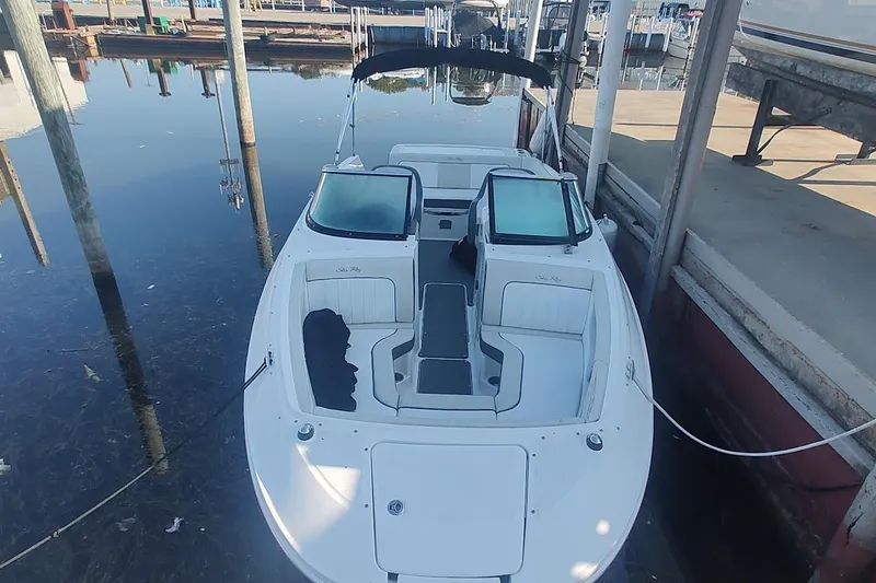Slide: The Image of 2013 Sea Ray 220 Sundeck boat docked in calm marina waters. - 5