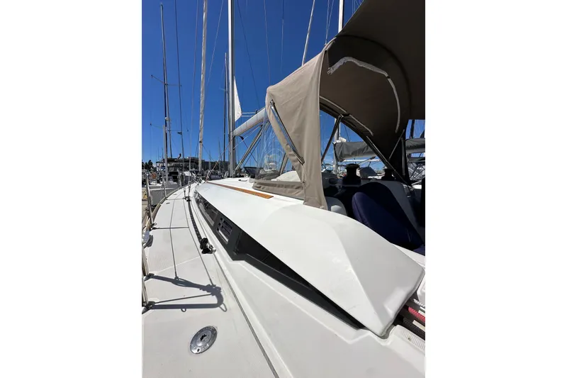 Slide: The Image of 2015 Jeanneau Sun Odyssey 409 sailboat docked in a marina under clear blue skies. - 11