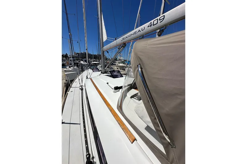 Slide: The Image of 2015 Jeanneau Sun Odyssey 409 yacht docked at marina, showcasing sleek design. - 12