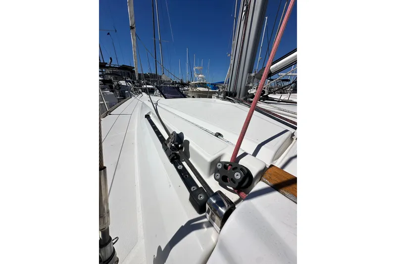 Slide: The Image of 2015 Jeanneau Sun Odyssey 409 sailboat deck view with clear blue sky. - 14