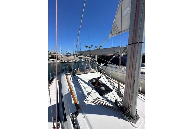 Slide: The Image of 2015 Jeanneau Sun Odyssey 409 sailboat docked in a marina under clear blue skies. - 20