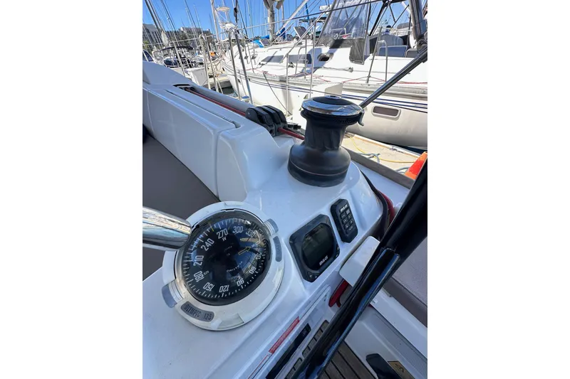 Slide: The Image of Steering wheel of 2015 Jeanneau Sun Odyssey 409 sailboat, docked with visible deck and seating. - 32