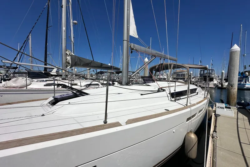 Slide: The Image of 2015 Jeanneau Sun Odyssey 409 sailboat docked in marina, clear blue sky. - 4
