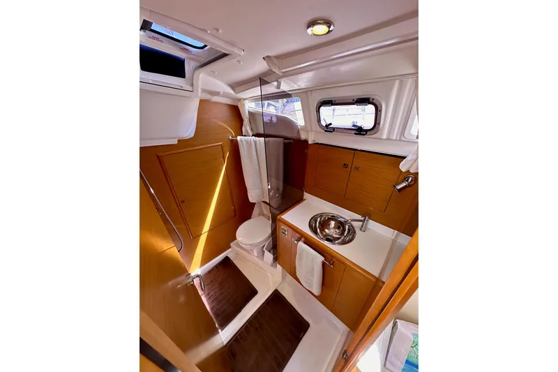 Slide: The Image of Interior of 2015 Jeanneau Sun Odyssey 409 yacht with modern furnishings and ample natural light. - 51