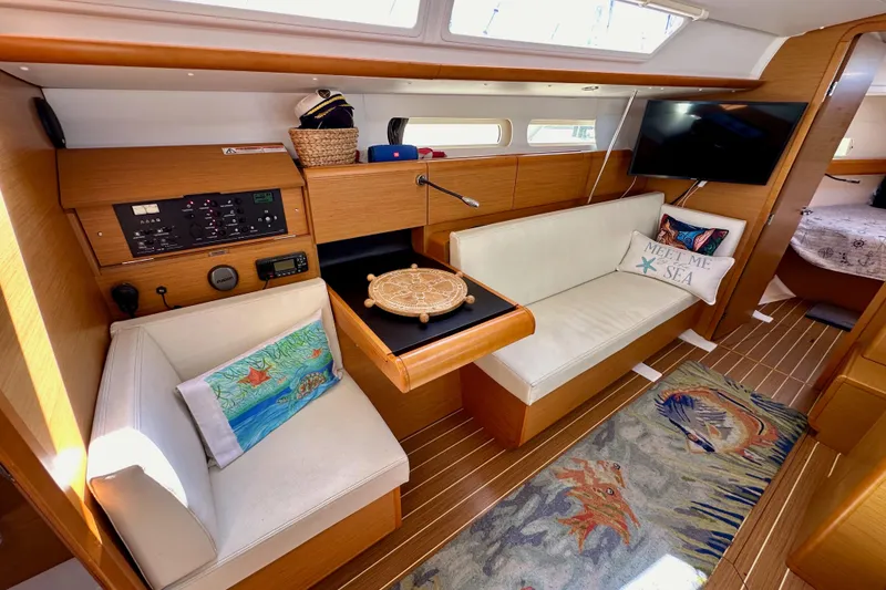 Slide: The Image of Luxurious interior of 2015 Jeanneau Sun Odyssey 409 sailboat, featuring modern wood finishes and cozy seating. - 57