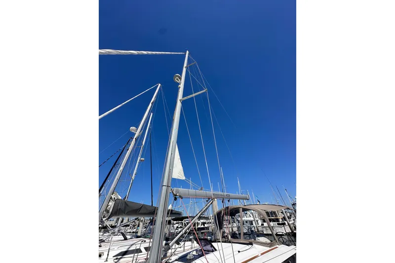 Slide: The Image of 2015 Jeanneau Sun Odyssey 409 sailboat docked at marina under clear blue sky. - 6