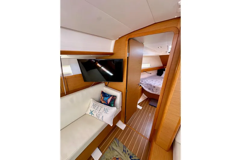 Slide: The Image of Interior of 2015 Jeanneau Sun Odyssey 409 yacht with cozy seating and nautical decor. - 62