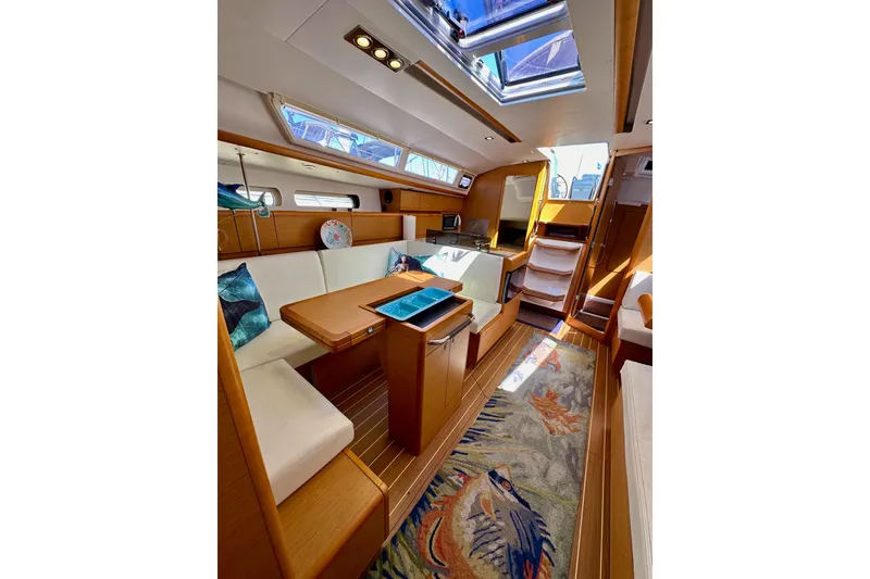 Slide: The Image of Interior cabin of 2015 Jeanneau Sun Odyssey 409 sailboat, featuring wooden cabinetry and nautical decor. - 68