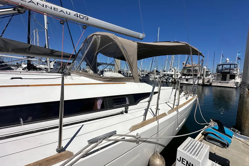 Slide: The Image of 2015 Jeanneau Sun Odyssey 409 sailboat docked under clear blue sky. - 7