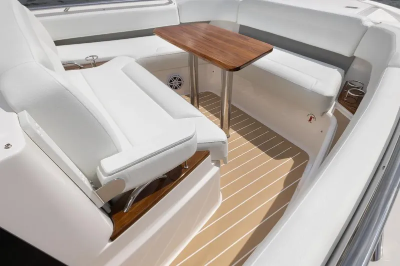 Slide: The Image of 2026 Tiara Yachts 39 interior with white seating and wooden table. - 11