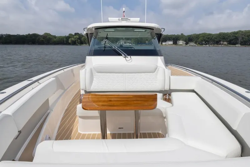 Slide: The Image of 2026 Tiara Yachts 39 with elegant seating and wooden table on calm waters. - 14