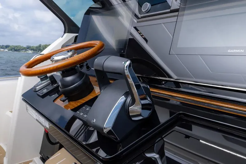 Slide: The Image of 2026 Tiara Yachts 39 helm with wooden steering wheel and modern controls. - 25