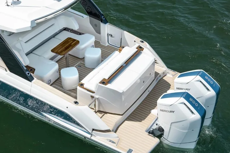 Slide: The Image of 2026 Tiara Yachts 39 with twin Mercury engines, featuring a spacious deck and seating area. - 3