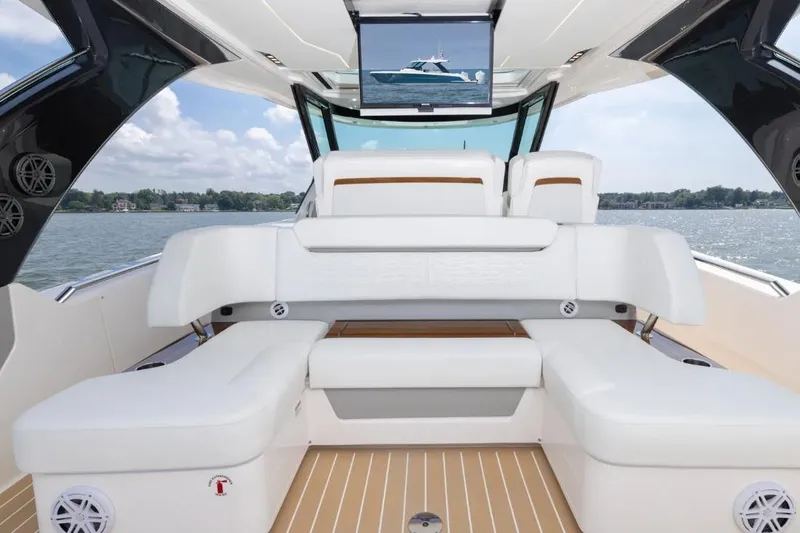 Slide: The Image of Luxurious 2026 Tiara Yachts 39 interior with white seating and scenic water view. - 8