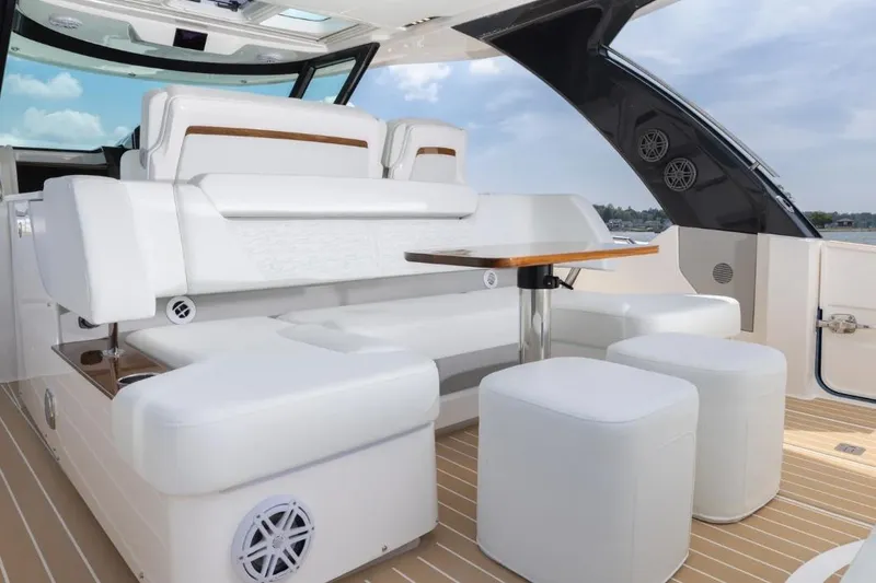 Slide: The Image of Luxurious seating area on 2026 Tiara Yachts 39, featuring elegant white upholstery and wooden accents. - 9