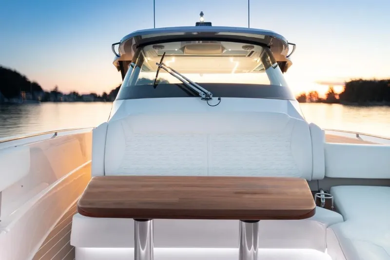 Slide: The Image of 2026 Tiara Yachts 39 boat interior with wooden table at sunset. - 15