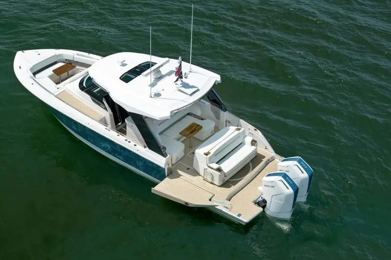 Slide: The Image of 2026 Tiara Yachts 39 model on water, featuring sleek design and powerful outboard engines. - 2