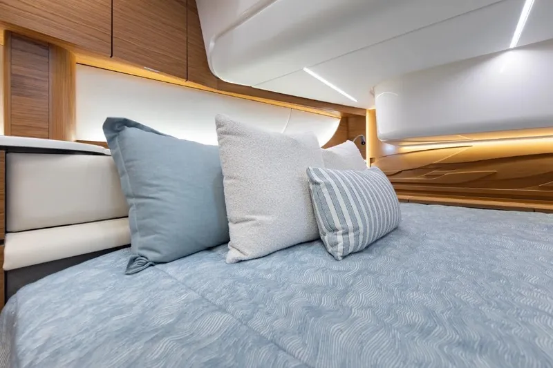 Slide: The Image of Luxurious interior of 2026 Tiara Yachts 39, featuring elegant bedding and modern design. - 22