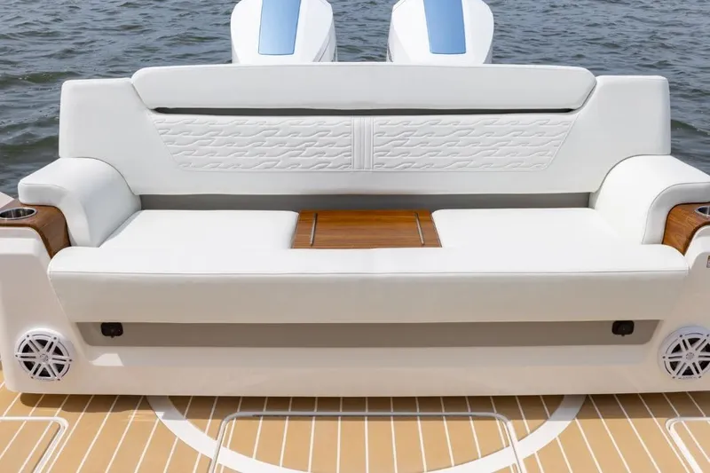 Slide: The Image of 2026 Tiara Yachts 39, luxurious white seating with wooden accents, on a boat deck. - 5