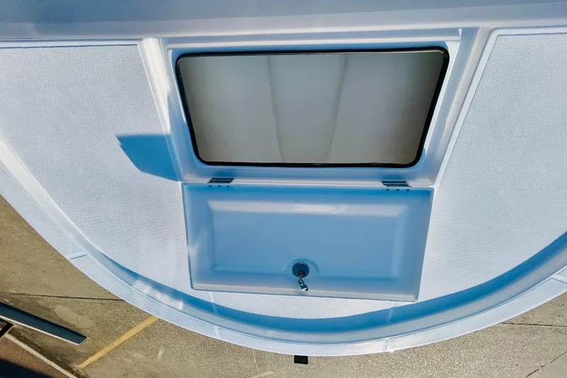 Slide: The Image of 2026 Shallow Sport 18 Sport boat deck with storage compartment and hatch. - 12