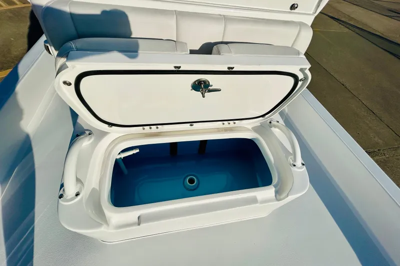 Slide: The Image of Open storage compartment on 2026 Shallow Sport 18 Sport boat, showcasing interior space. - 14