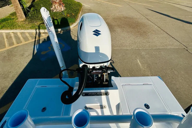 Slide: The Image of 2026 Shallow Sport 18 Sport boat with Suzuki outboard motor in parking lot. - 15