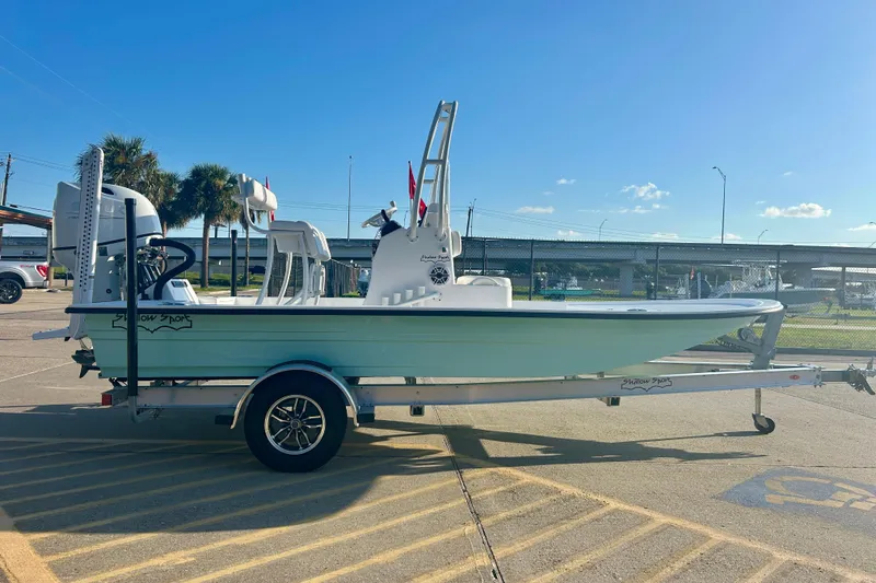 Slide: The Image of 2026 Shallow Sport 18 Sport boat on trailer in sunny parking lot. - 4