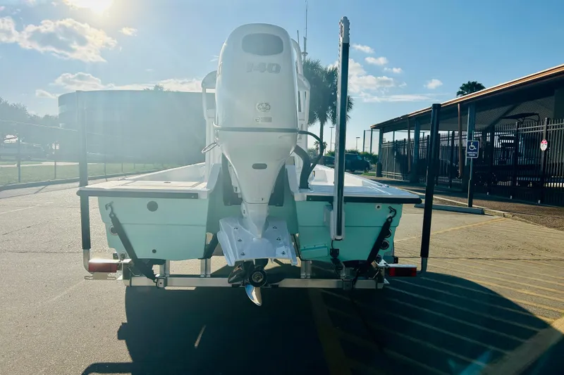 Slide: The Image of 2026 Shallow Sport 18 Sport boat on trailer, sunny day, parking lot background. - 6