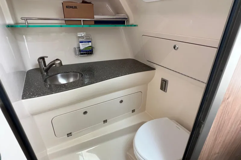 Slide: The Image of 2019 Boston Whaler 315 Conquest bathroom with sink, toilet, and storage. - 12
