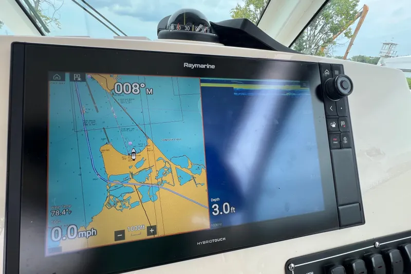 Slide: The Image of Raymarine navigation display on 2019 Boston Whaler 315 Conquest, showing map and depth information. - 13