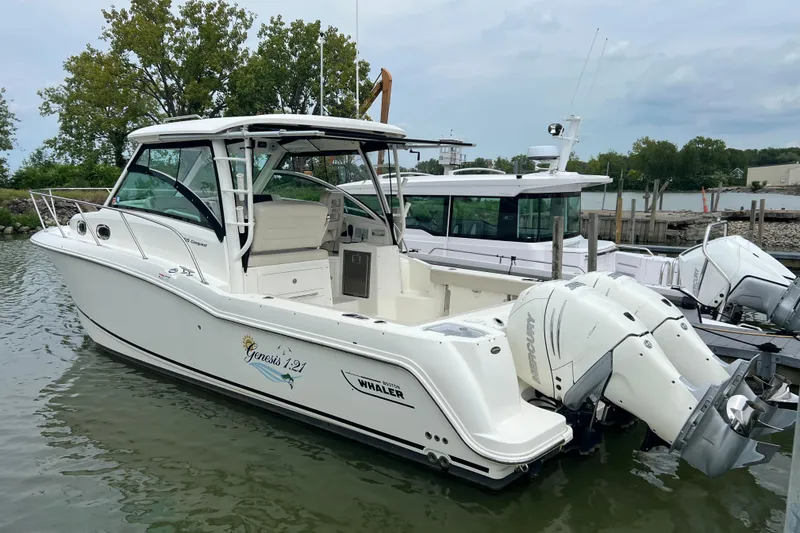 Slide: The Image of 2019 Boston Whaler 315 Conquest boat docked with twin Mercury engines. - 4
