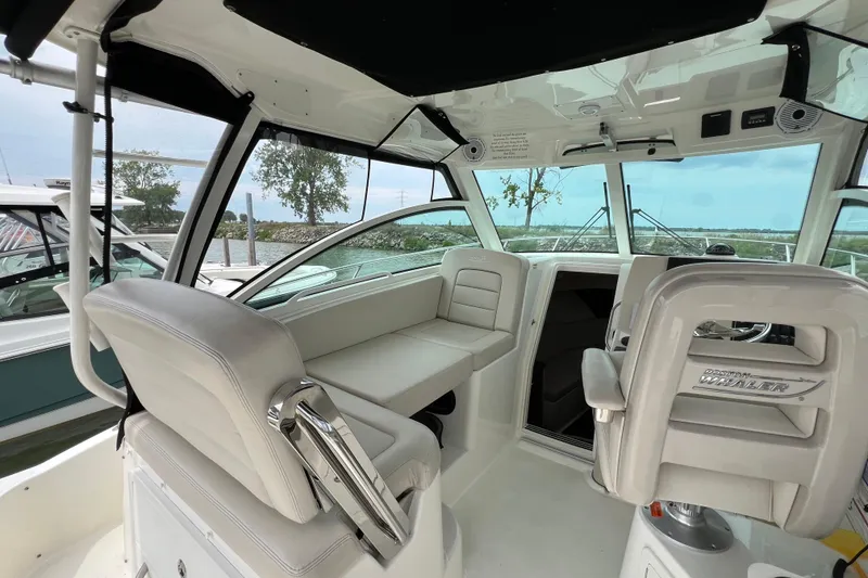 Slide: The Image of 2019 Boston Whaler 315 Conquest interior with plush seating and modern helm. - 8
