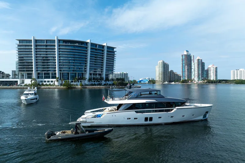Slide: The Image of Luxurious 2020 Sanlorenzo SX88 yacht cruising near modern waterfront buildings. - 10