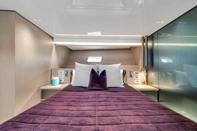 Slide: The Image of Luxurious Sanlorenzo SX88 2020 yacht bedroom with plush purple bedding and modern decor. - 104