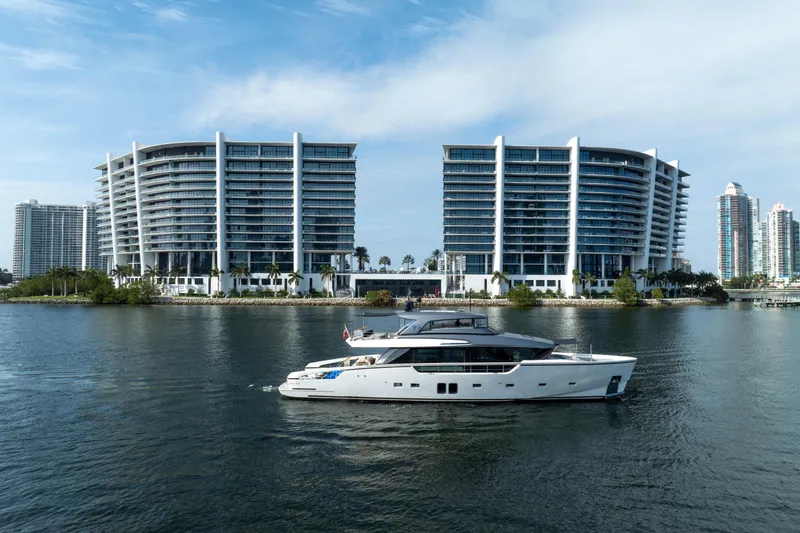 Slide: The Image of Sanlorenzo SX88 yacht cruising near modern waterfront buildings, 2020 model. - 11