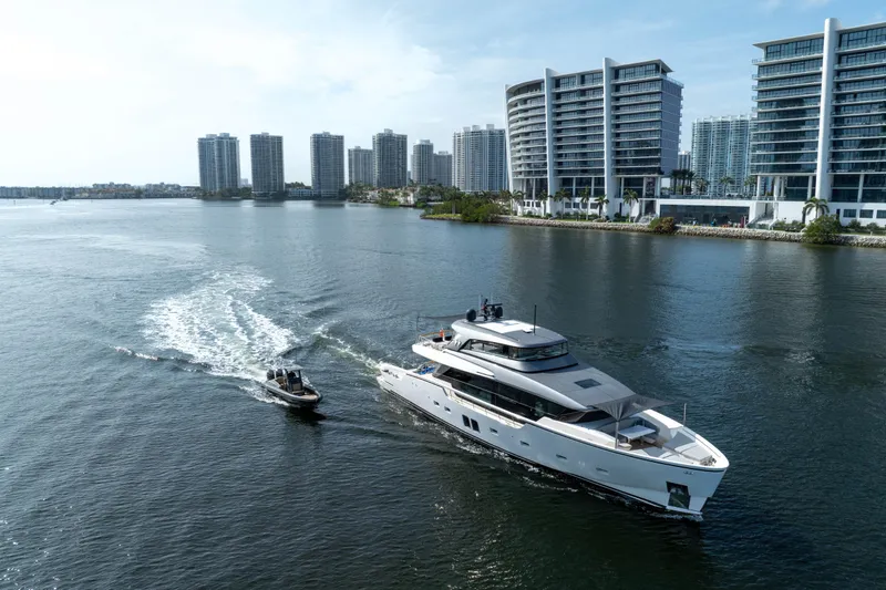 Slide: The Image of Sanlorenzo SX88 yacht cruising near modern waterfront buildings, 2020 model. - 12