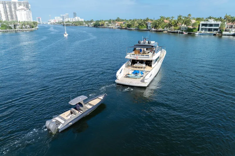 Slide: The Image of Sanlorenzo SX88 yacht cruising alongside a smaller boat in a scenic waterway. - 15
