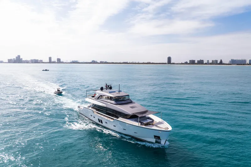 Slide: The Image of 2020 Sanlorenzo SX88 yacht cruising on blue ocean near city skyline. - 20