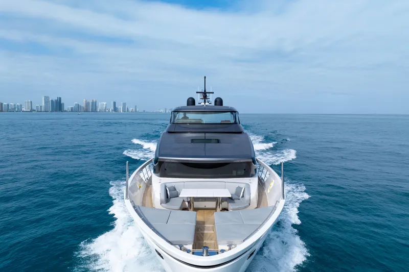 Slide: The Image of Sanlorenzo SX88 2020 yacht cruising on open sea with city skyline in background. - 26