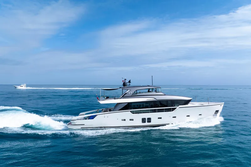 Slide: The Image of Luxury 2020 Sanlorenzo SX88 yacht cruising on open sea under clear blue sky. - 28