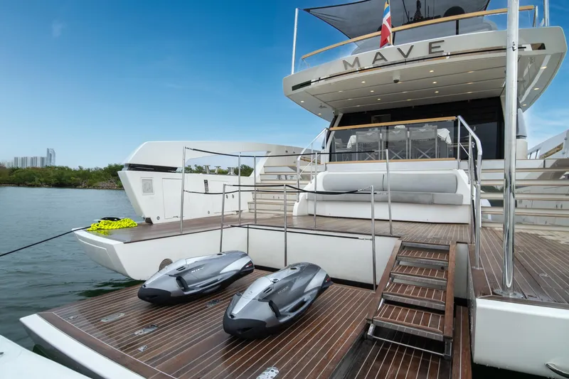 Slide: The Image of Luxury Sanlorenzo SX88 yacht, 2020 model, with jet skis on the deck, docked by the water. - 4
