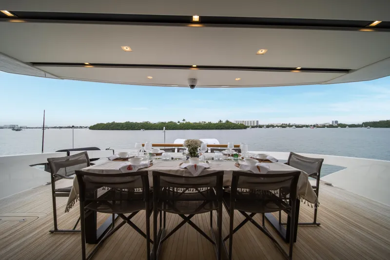 Slide: The Image of Luxury dining setup on 2020 Sanlorenzo SX88 yacht overlooking serene waters. - 52