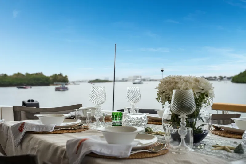 Slide: The Image of Elegant dining setup on Sanlorenzo SX88 yacht, 2020, with scenic water view. - 58