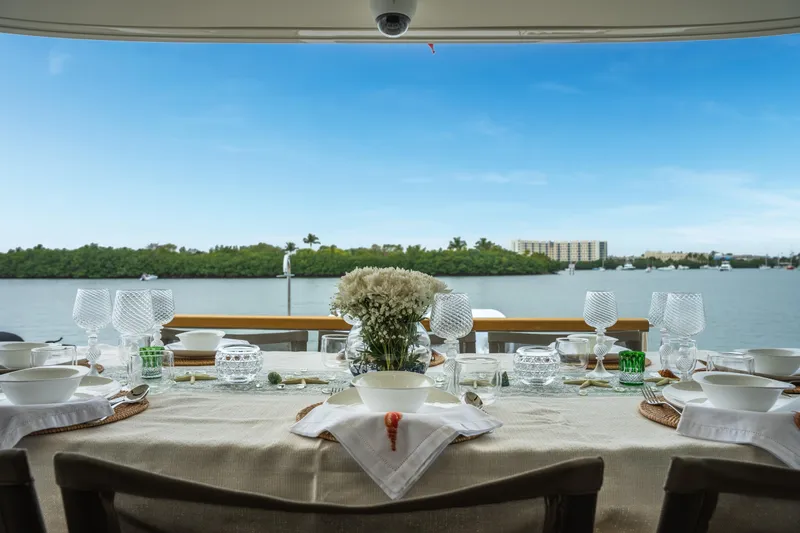 Slide: The Image of Elegant dining setup on Sanlorenzo SX88 yacht, overlooking serene waterfront view. - 59