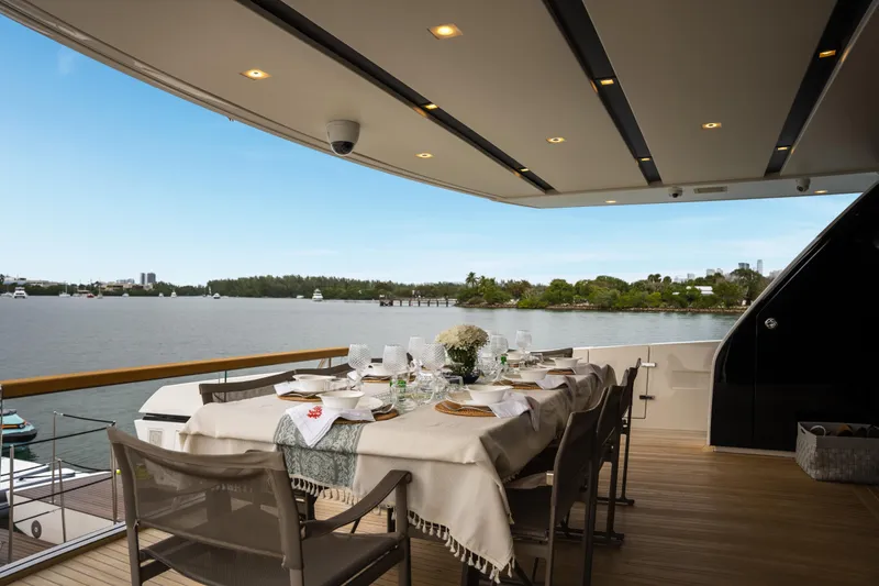 Slide: The Image of Luxury dining setup on Sanlorenzo SX88 yacht, 2020, overlooking serene waterfront. - 60