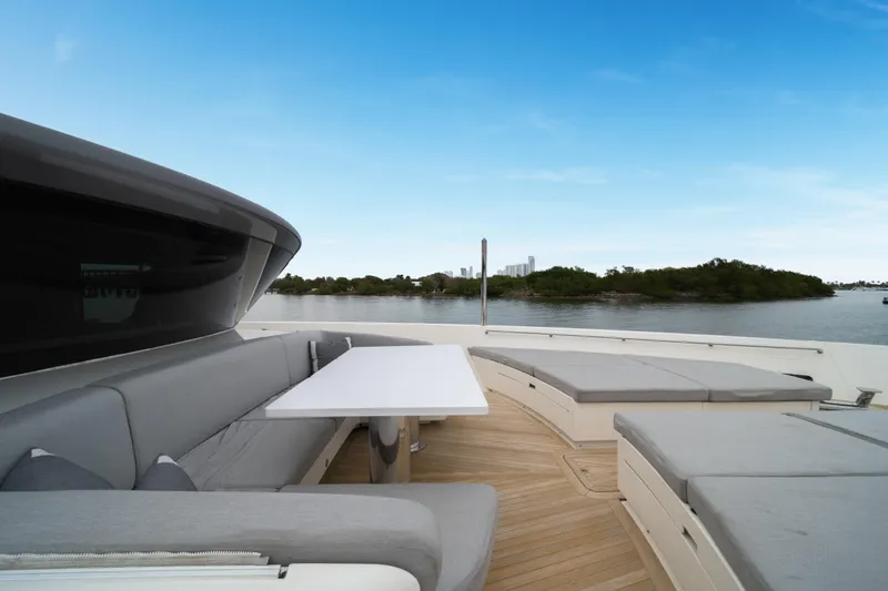 Slide: The Image of Luxurious 2020 Sanlorenzo SX88 yacht deck with seating and scenic water view. - 63