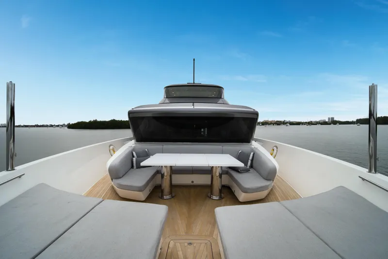 Slide: The Image of Sanlorenzo SX88 2020 yacht deck with seating area and table, overlooking calm waters. - 64