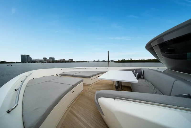 Slide: The Image of Luxurious 2020 Sanlorenzo SX88 yacht deck with modern seating and scenic waterfront view. - 65