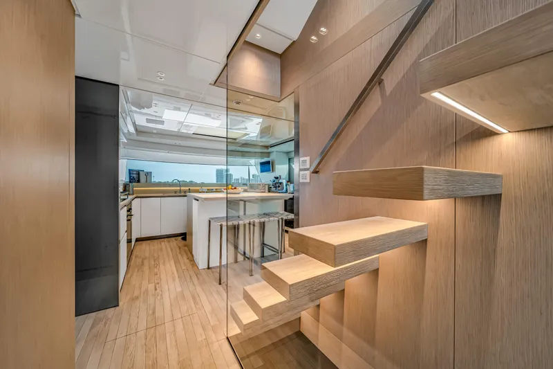 Slide: The Image of Modern interior of 2020 Sanlorenzo SX88 yacht with sleek wooden staircase and kitchen area. - 74